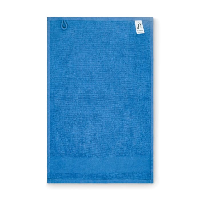 A blue towel featuring a hanging loop, with a small branded tag in the top corner.