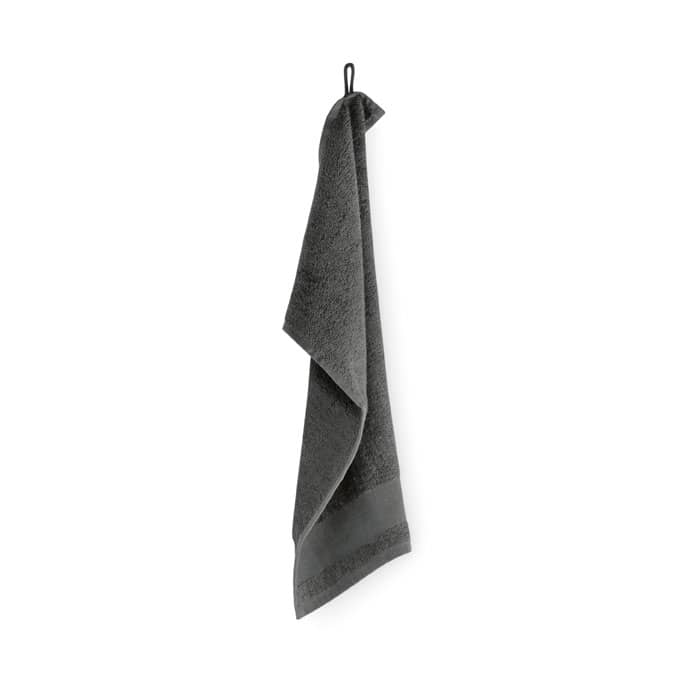 A grey towel hangs from a hook, showcasing its soft texture and simple design. It has a loop for hanging.