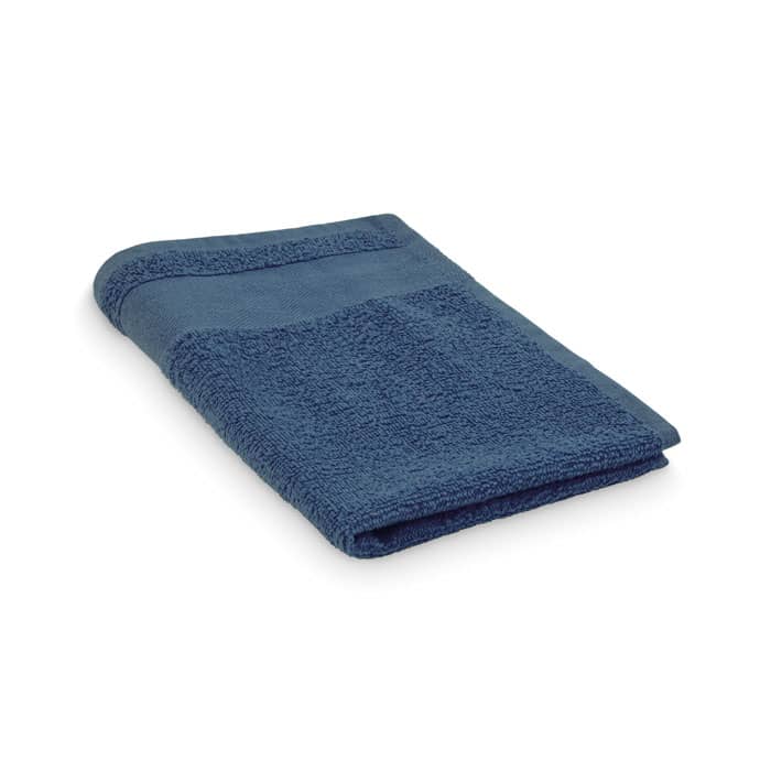 A folded blue towel with a textured surface, featuring a plain band along the edge. It has a simple design and is soft.