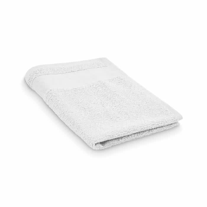 A white towel neatly folded, featuring a textured surface and a simple stitched border.