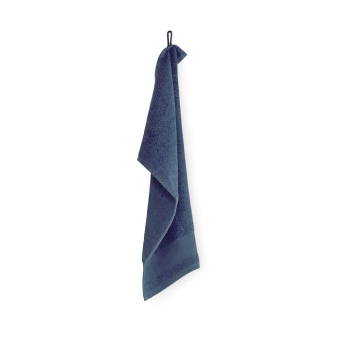 A dark blue towel hanging vertically, featuring a loop for easy storage.