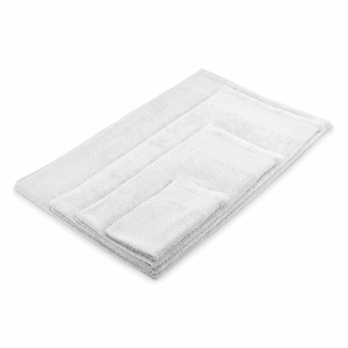 A set of white towels, including different sizes and a textured design, arranged neatly on a flat surface.