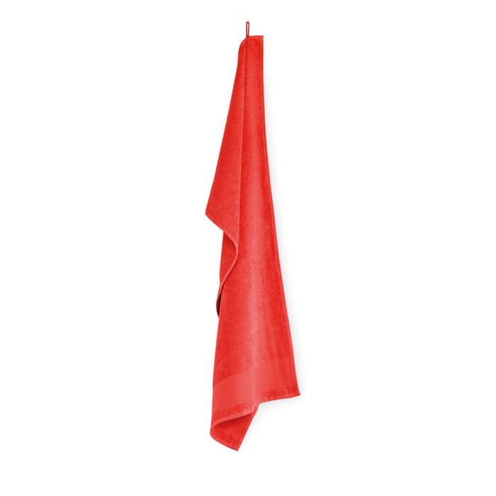 A red towel hanging on a hook, featuring a soft texture and a smooth finish.