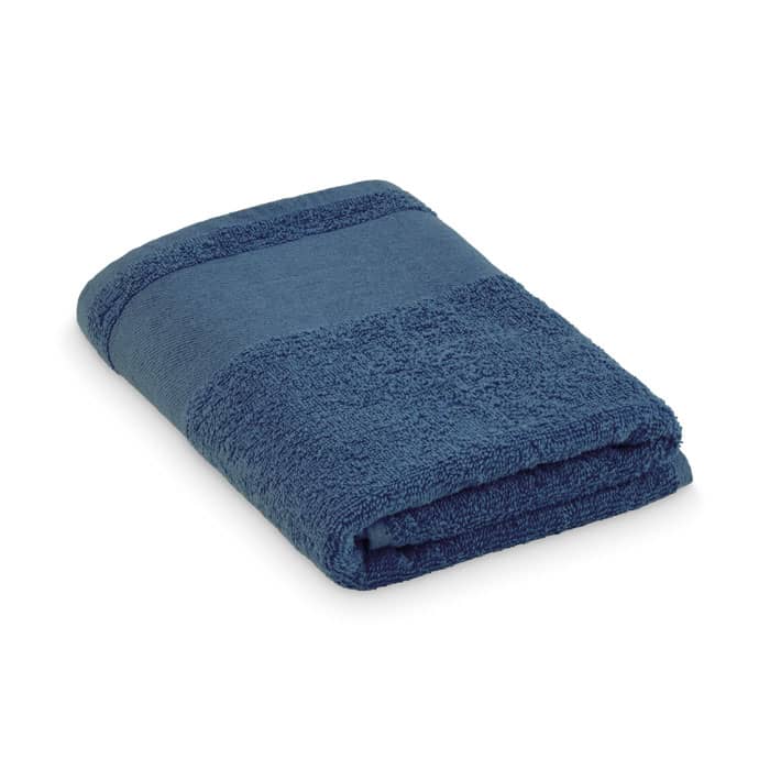 A folded towel in a deep navy blue colour featuring a textured stripe design.