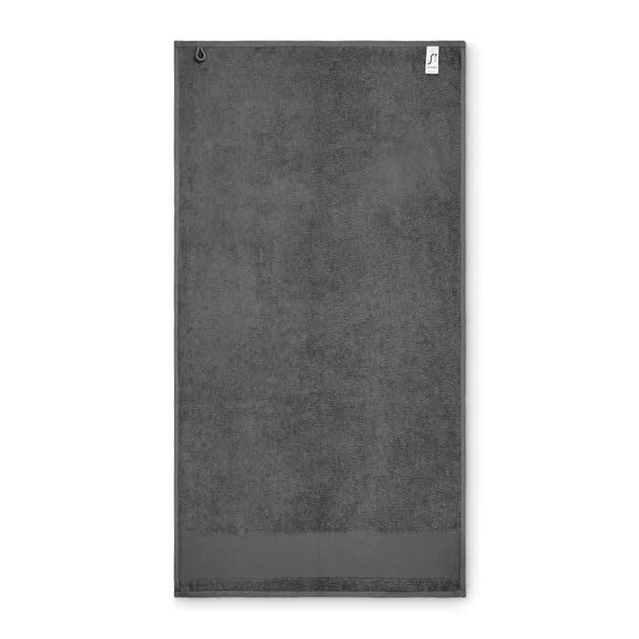 A grey towel with a loop for hanging, featuring a textured, plush surface. The towel has a simple design.