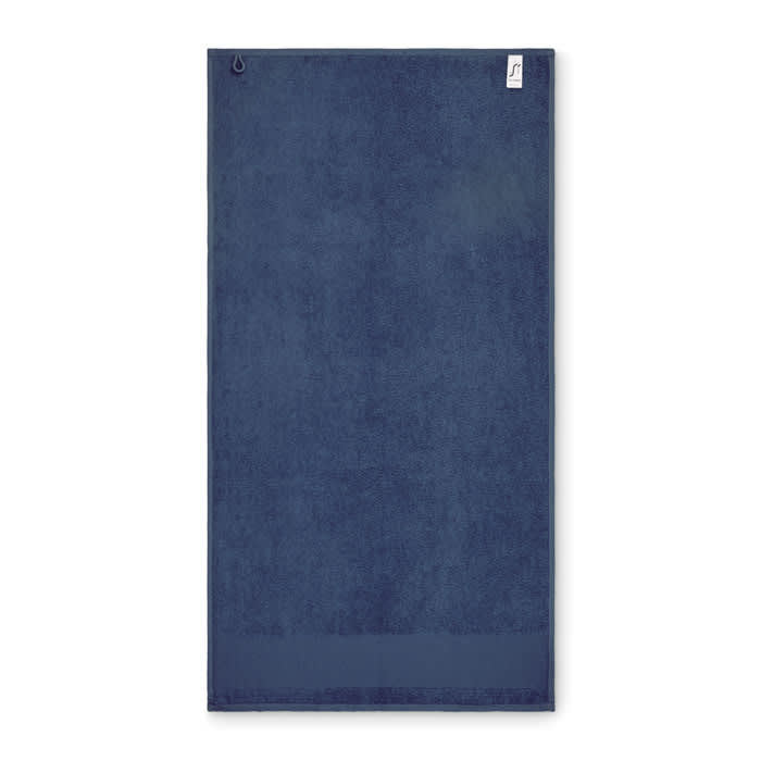 A navy blue beach towel with a loop for hanging and a small tag, featuring a simple, solid design.