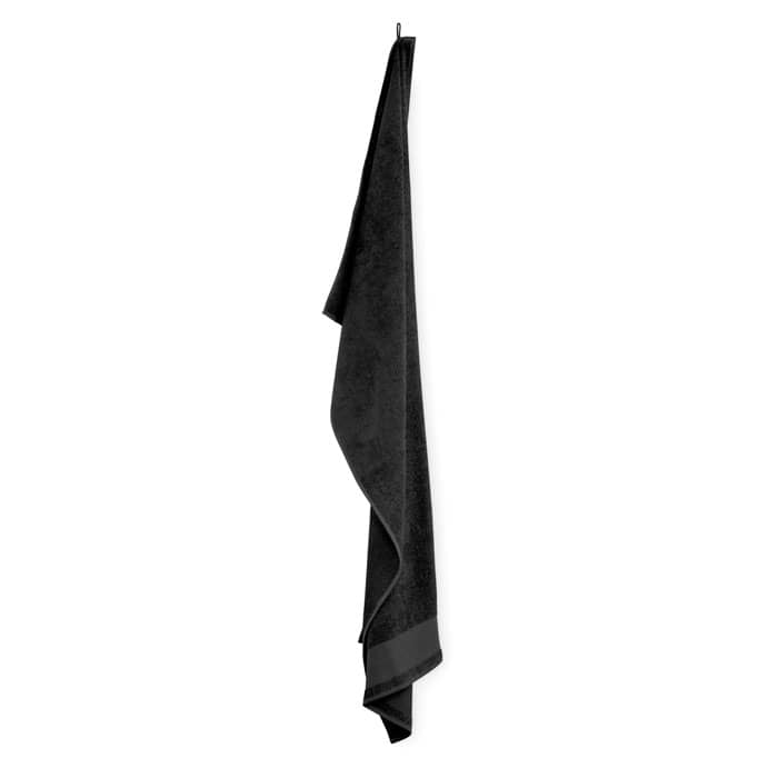 A black towel hanging on a hook. It has a plain design and a soft texture.