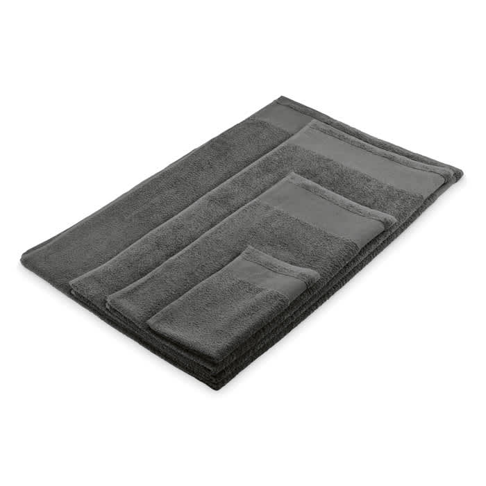 A set of grey bath towels arranged neatly, including different sizes for various uses. The towels have a soft texture.