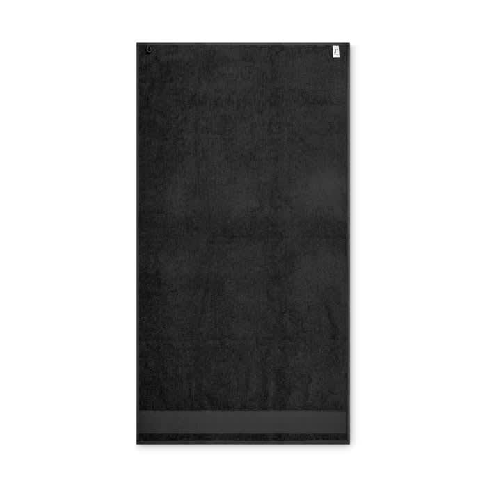 A black towel featuring a smooth texture and a hanging loop. It includes branding on one side.