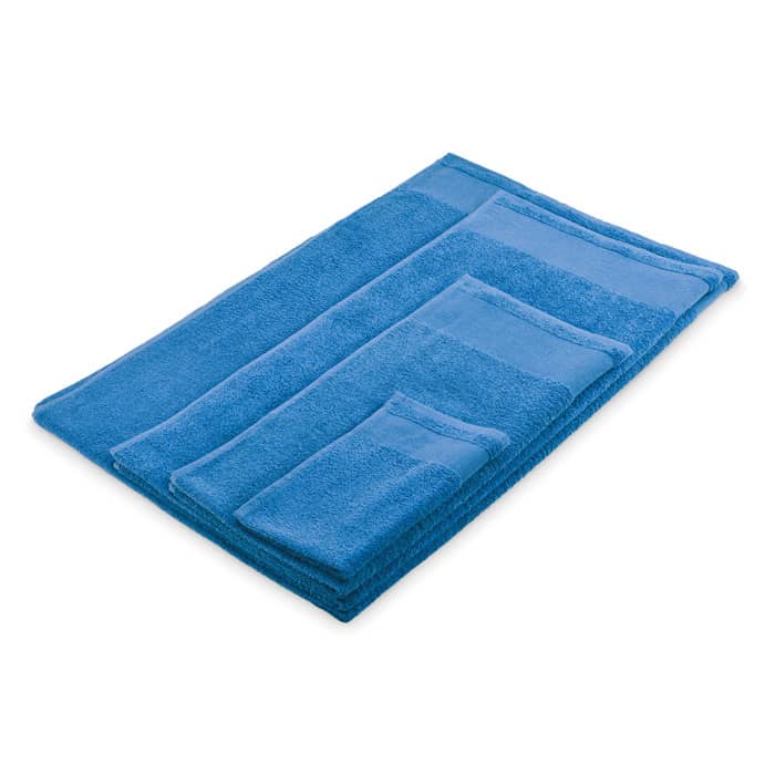 A set of blue towels in various sizes, stacked neatly on a flat surface.