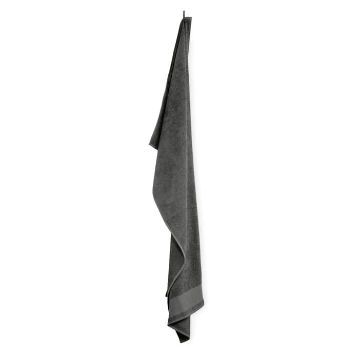 A grey towel hanging from a hook, displaying a smooth texture and a simple design.