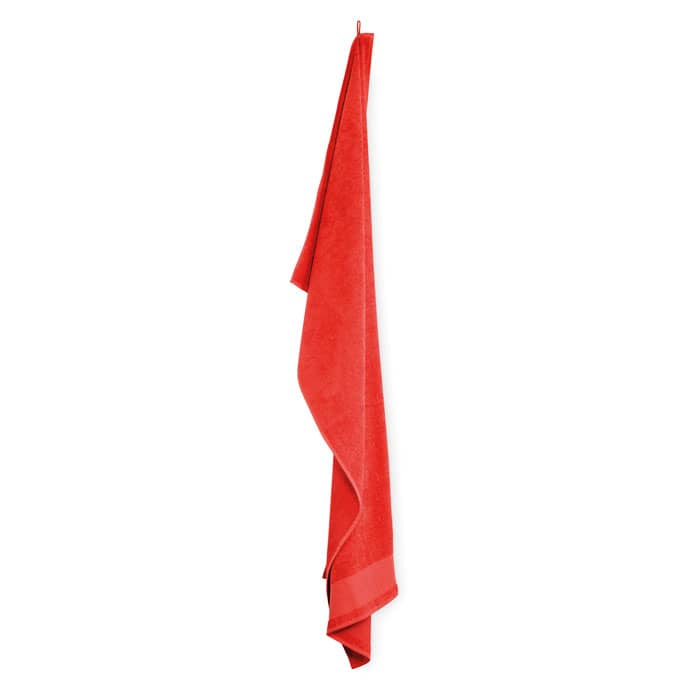 A red towel hanging against a white background, featuring a simple design and no visible branding.