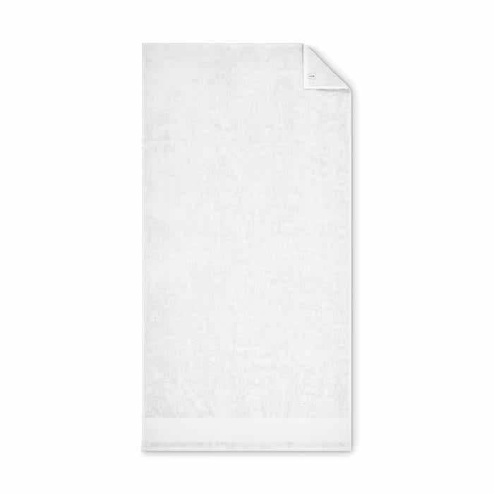 A white towel with a subtle textured pattern and a folded corner, featuring a branding logo.