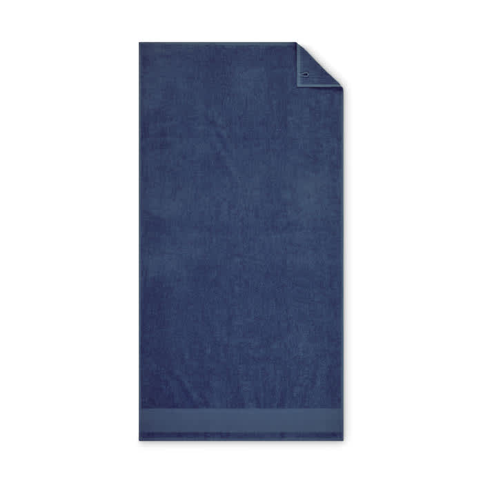 A navy blue towel with a folded corner, featuring a smooth texture and simple design.