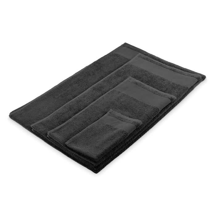 A set of black towels in various sizes arranged neatly. The towels have a soft, textured appearance.