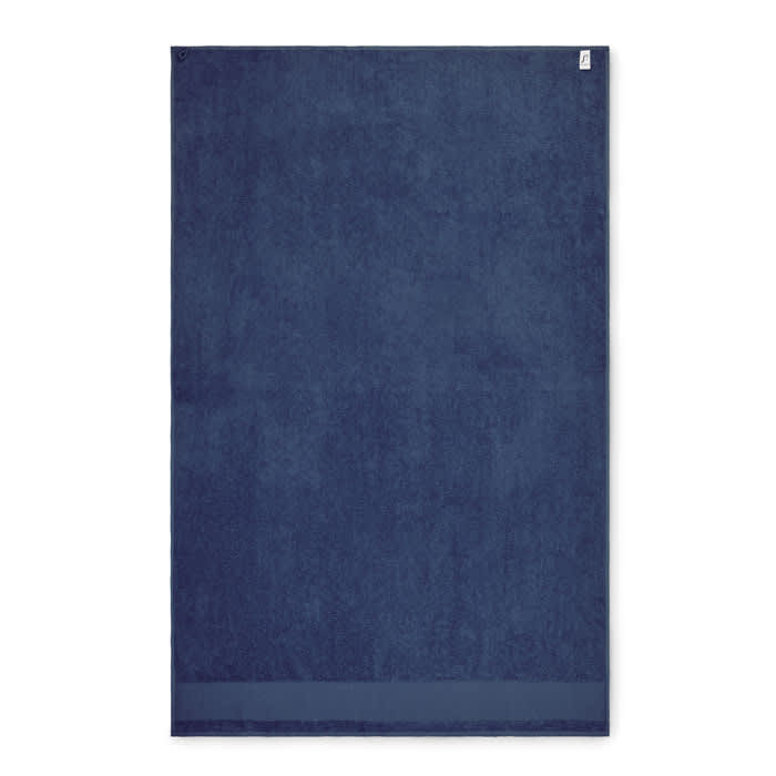 A navy blue towel featuring a simple design with a folded hem at the bottom and a logo in one corner.