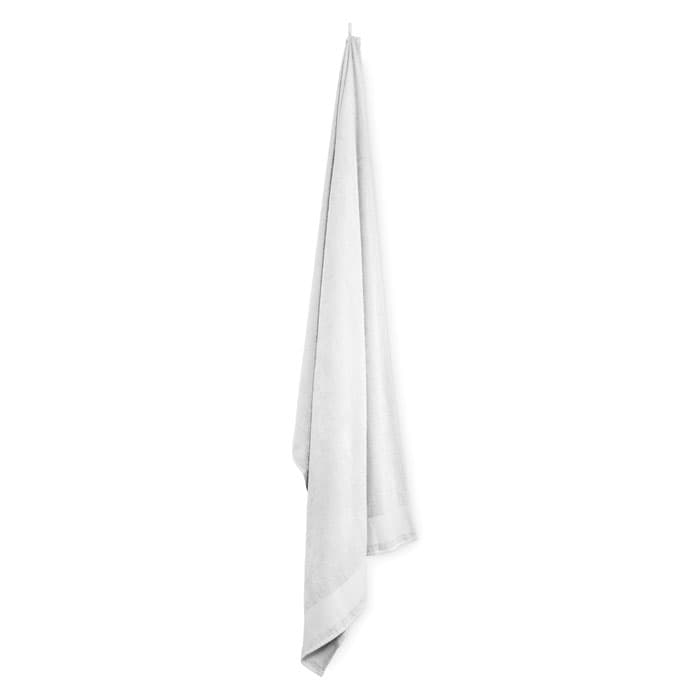 A white towel hangs from a hook, showcasing a soft and textured fabric. The towel has a simple, classic design.