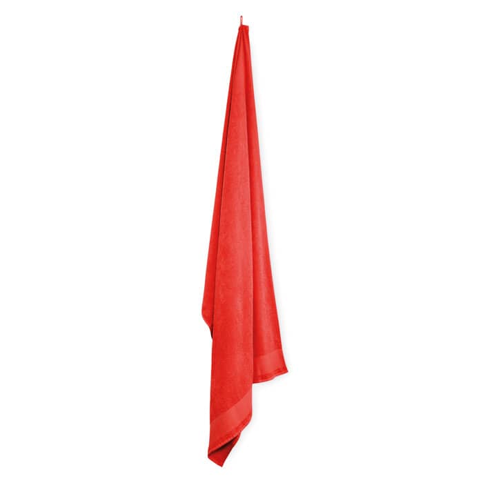 A red towel draped elegantly, featuring a smooth texture and a hanging loop for easy storage.