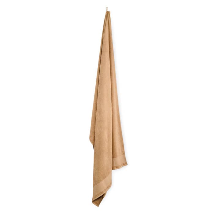 A brown towel hanging elegantly, featuring a smooth texture and simple design.