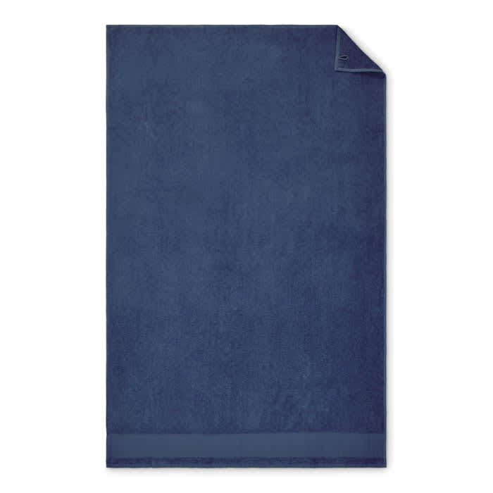 A navy blue towel featuring a folded corner and a smooth hem, with a branding logo present.