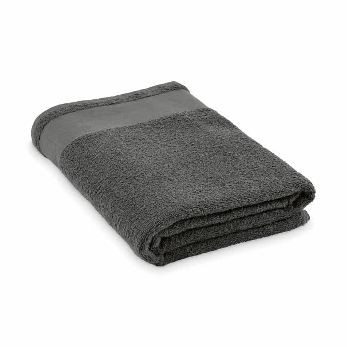 A folded grey towel with a textured finish and a smooth striped band. The towel has a simple design.