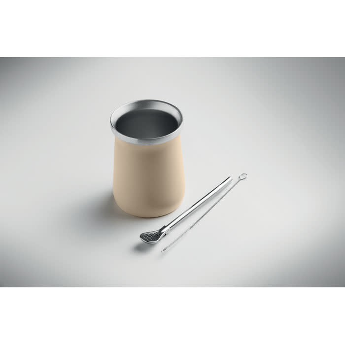 A drink bottle in beige with a silver rim, accompanied by a stainless-steel tongs.