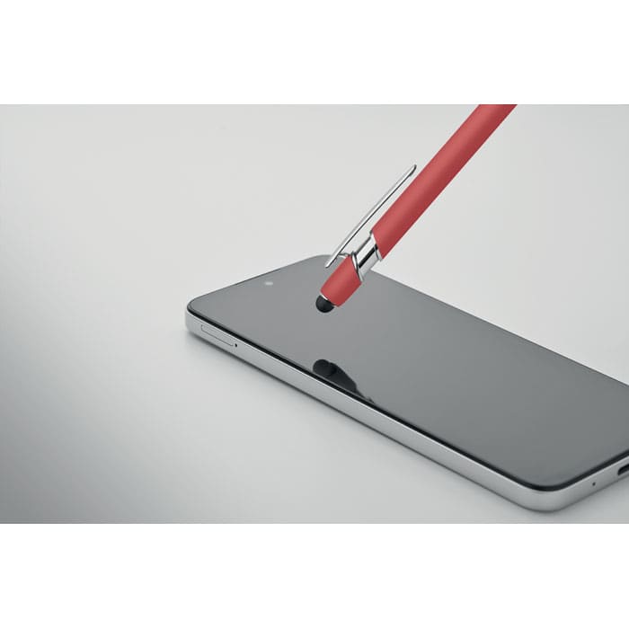 A red stylus pen rests on a sleek black smartphone, with a reflective surface and silver detailing.