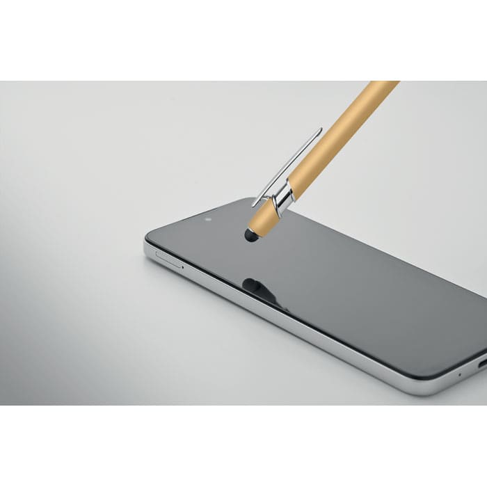 A stylus pen with a gold finish is shown touching the screen of a sleek black smartphone.