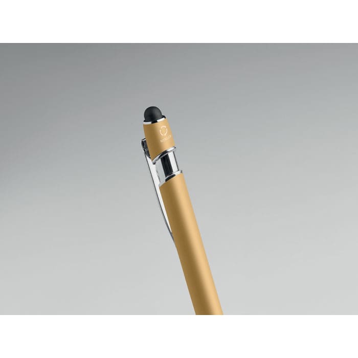A pen in a gold and clear design featuring a black tip and a logo on the clip.