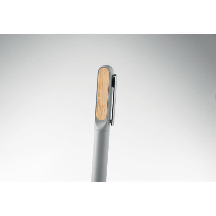 A pen in grey with a wooden touch on the clip. The design is sleek and modern.
