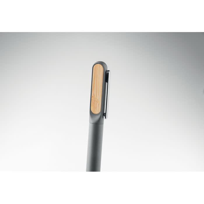 A pen with a sleek grey body and a bamboo accent on the top, featuring a clip for easy attachment.