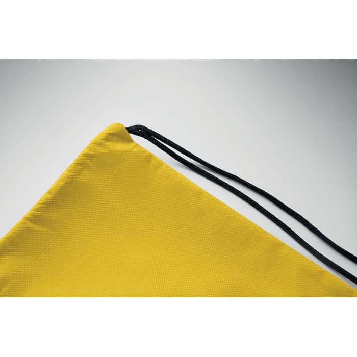 A drawstring bag in bright yellow with a black cord closure, featuring a textured fabric.