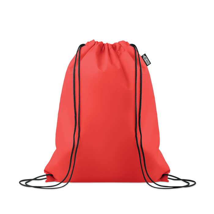 A red drawstring backpack with black cord straps and a branded tag on the side.