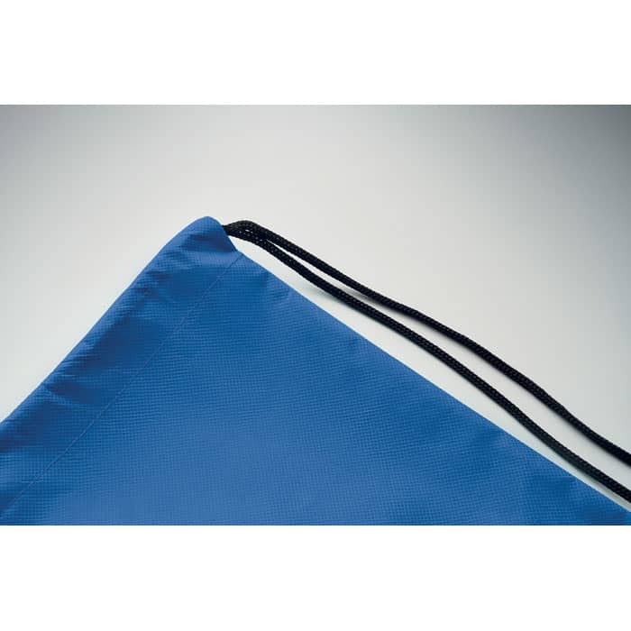 A blue drawstring bag with a textured surface and black drawcords is displayed against a light background.