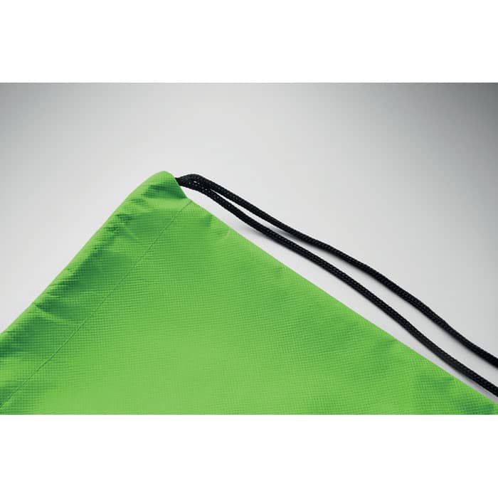 A green drawstring bag with a black cord, featuring a textured surface and a simple design.