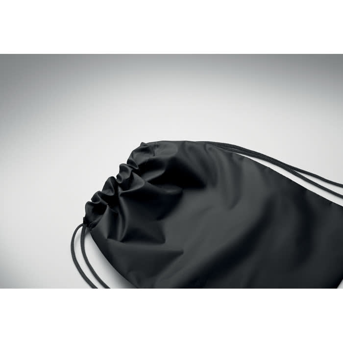 A black drawstring backpack featuring a smooth finish and contrasting cord. It has a simple, minimalist design.