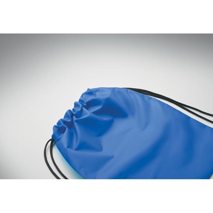 A blue drawstring backpack with black cords, featuring a plain design and no visible branding.
