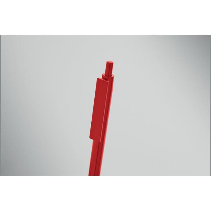 A red pen with a retractable tip, featuring a simple design and a clip for easy attachment.