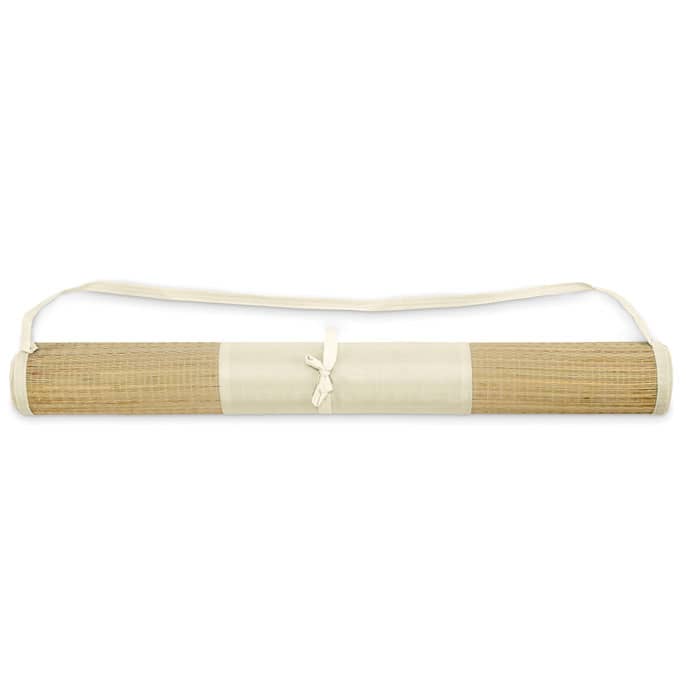 A natural-coloured raffia roll with a cream strap, featuring a tied design for securing.