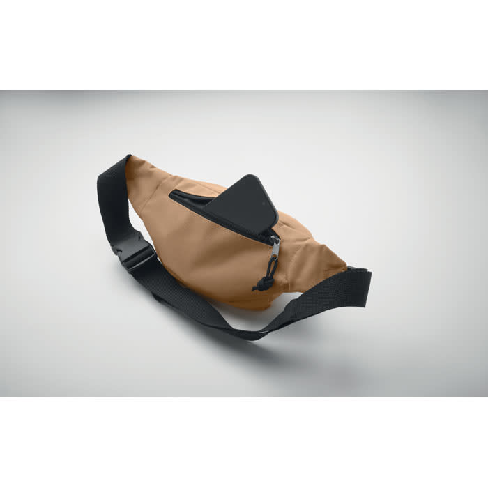 A tan waist bag with a black strap and a zippered pocket, featuring a sleek design and minimalist style.