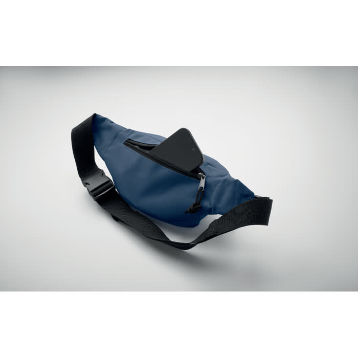 A blue hip bag with a black adjustable strap and a zippered pocket. It features a sleek design and a small phone resting on top.