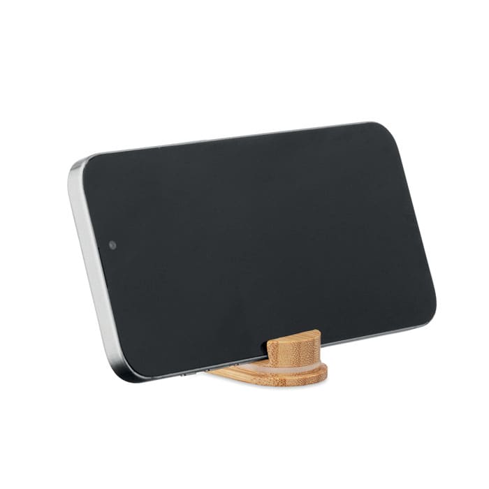 A smartphone on a wooden stand. The phone has a sleek black design and features a simple, modern aesthetic.