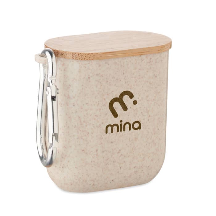 A storage container in a cream colour with a bamboo lid, featuring a carabiner and a logo.