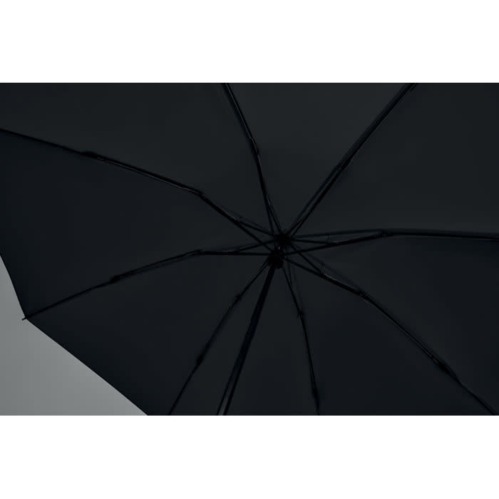 A black umbrella viewed from underneath, showcasing its structure and spokes. It features a simple design.