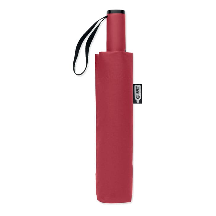 A red umbrella with a sleek design, featuring a strap for easy carrying and a small branding tag.