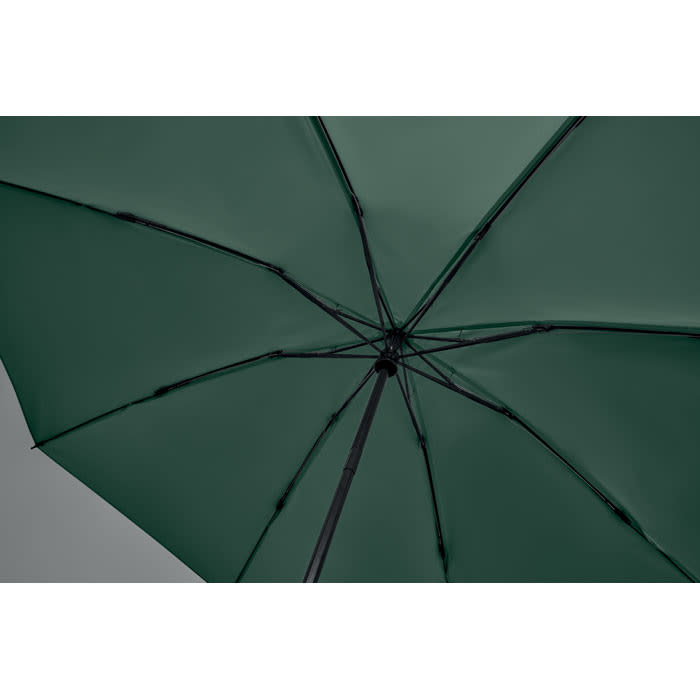 A green umbrella featuring a black handle and frame, viewed from underneath. It has a smooth canopy design.