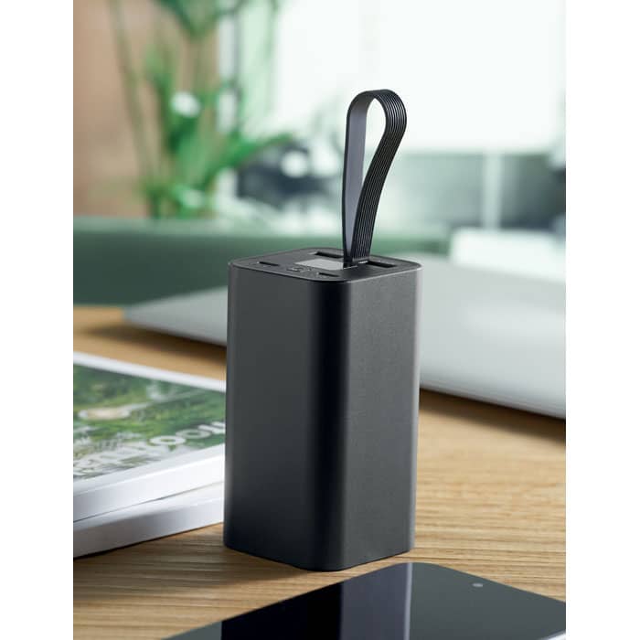 A drink bottle in a sleek black design, featuring a carrying strap and a minimalistic aesthetic on a wooden surface.