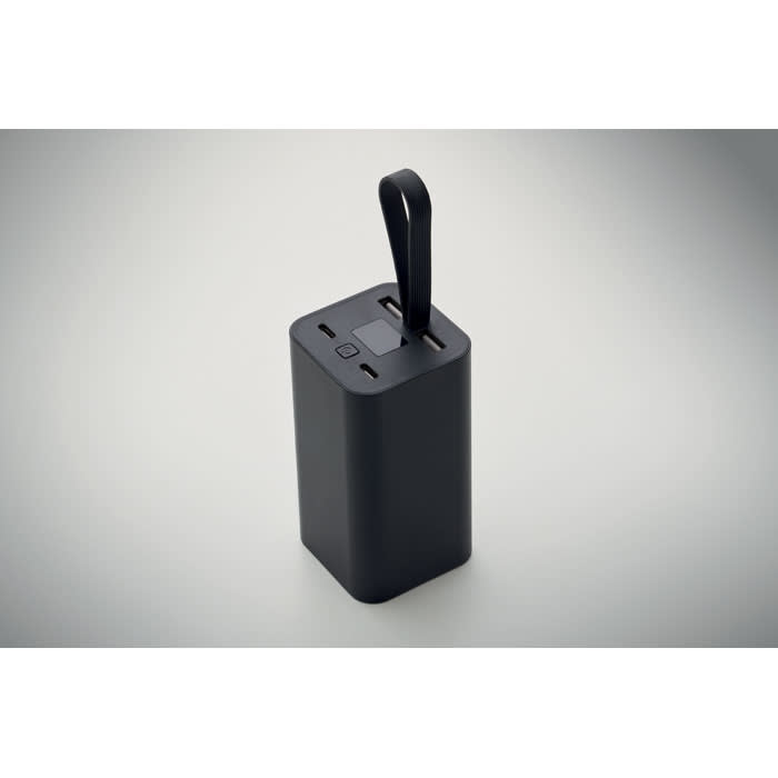 A black portable power bank with a handle, featuring multiple charging ports on the top.