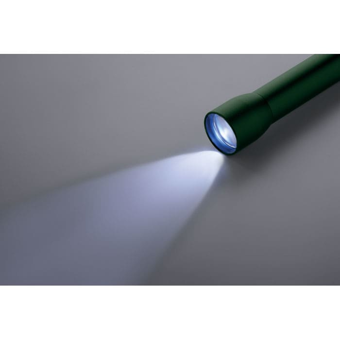 A green flashlight casting a blue beam of light on a grey surface, featuring a simple design and a branding logo.