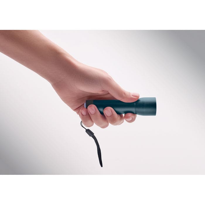A handheld flashlight in a green metallic finish, featuring a wrist strap.